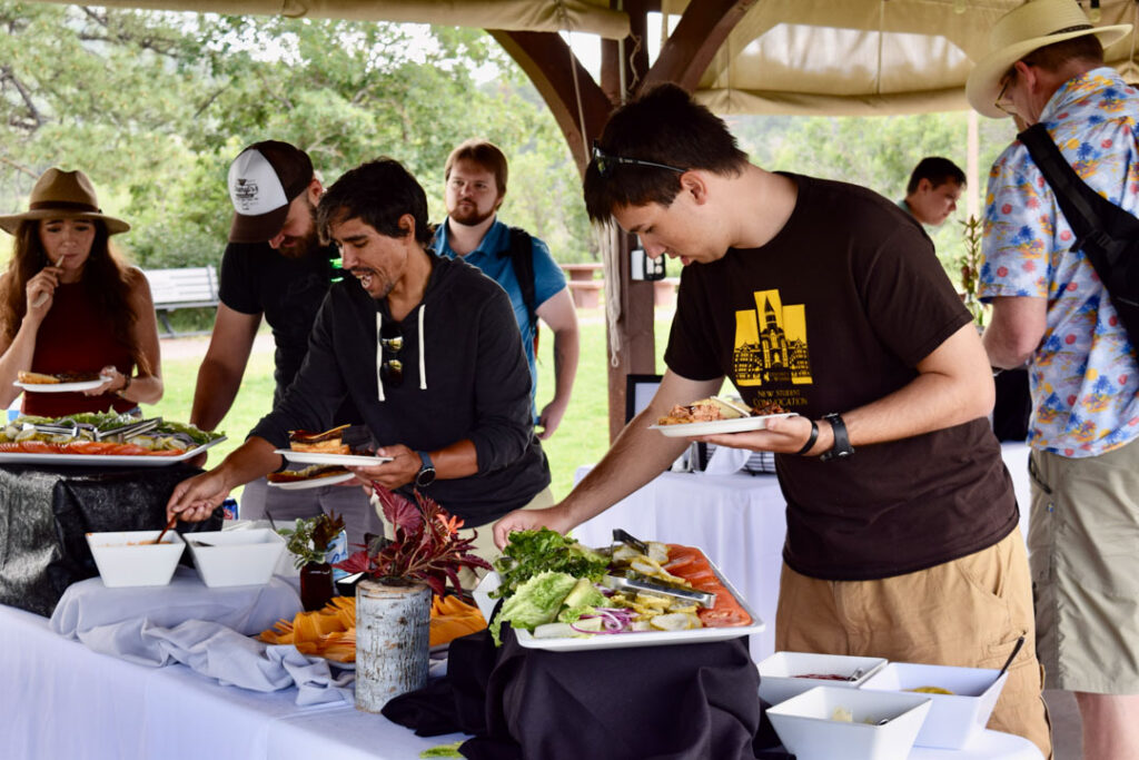 ARKA employees enjoying the buffet at the company picnic.