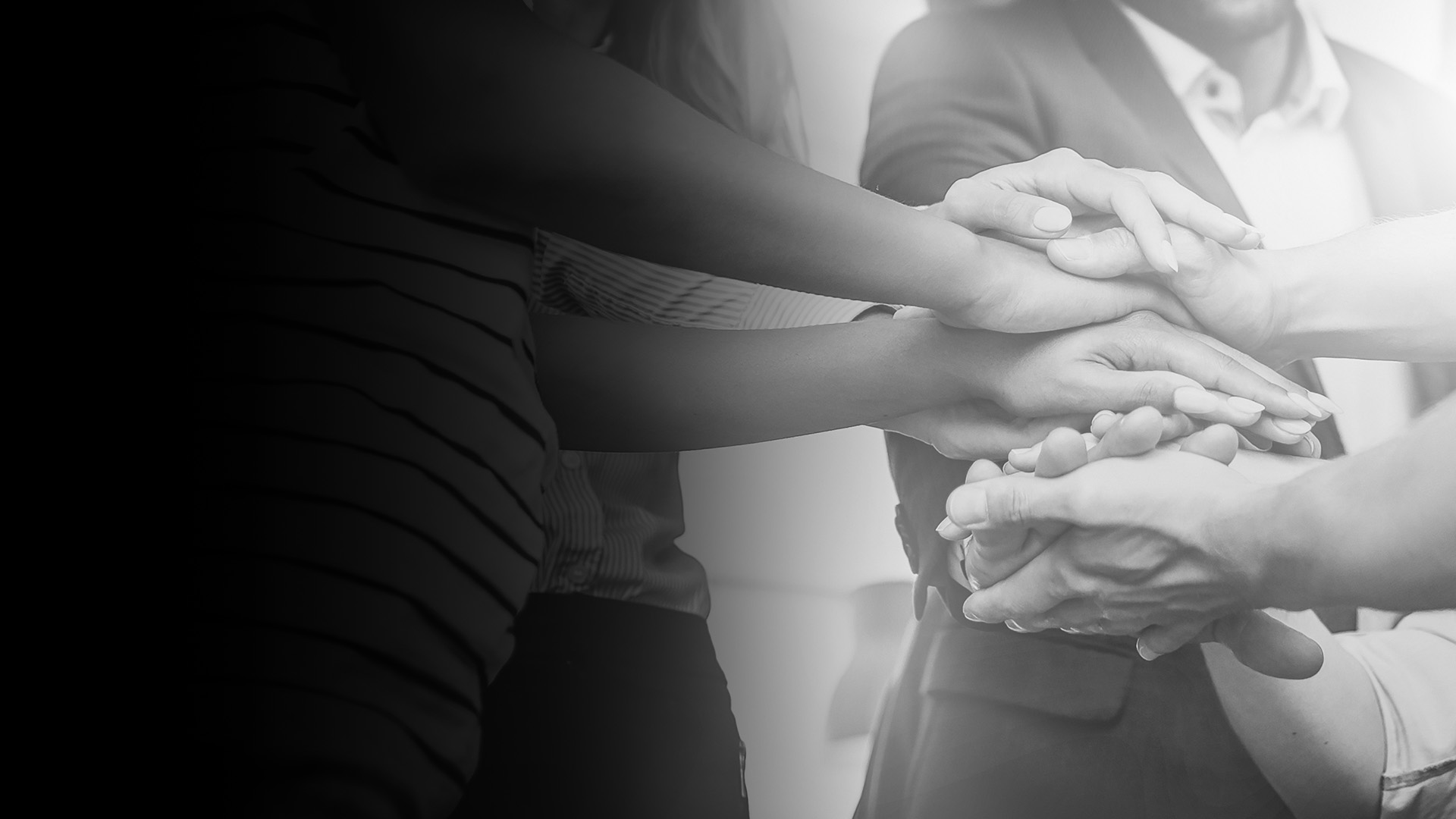 A group of people stacking their hands over each other.