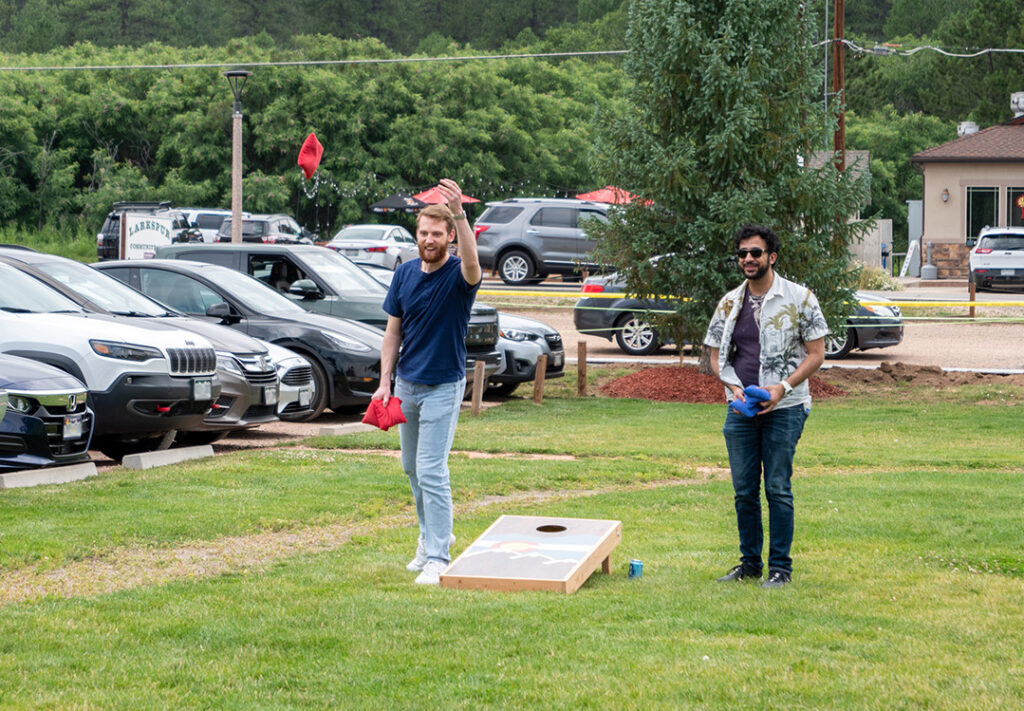 two young men playing corn hole