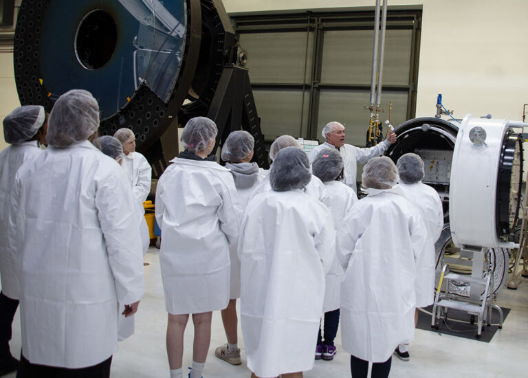 Tour guide speaking to a group in a lab